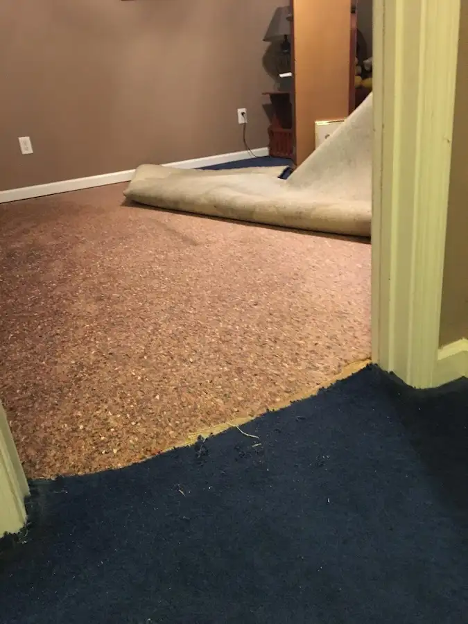 Carpet pad removal revealing water damage during Drying & Dehumidification in Aztec